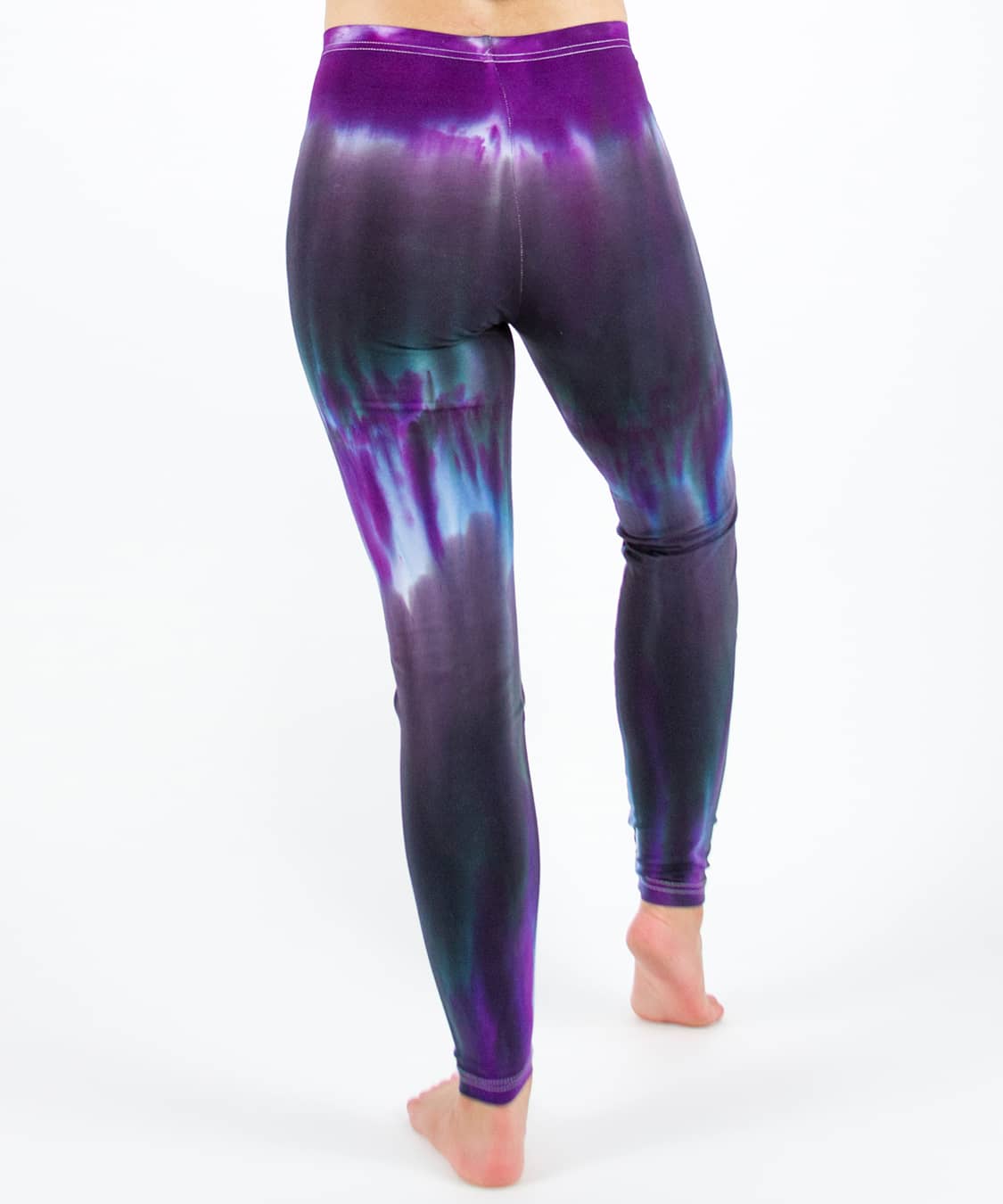 Woman wearing cotton black and purple tie dye leggings.