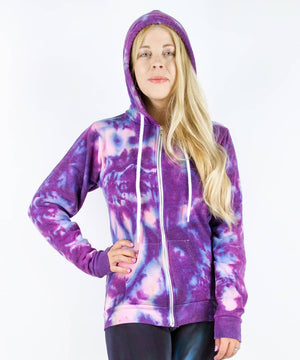 Woman wearing a purple and pink tie dye hoodie jacket with a zipper.