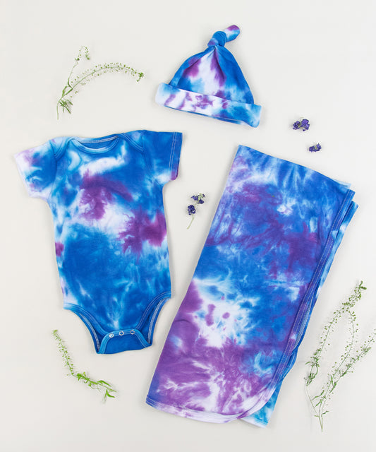 Blue and purple tie dye organic baby bodysuit, hat, and blanket by Akasha Sun.