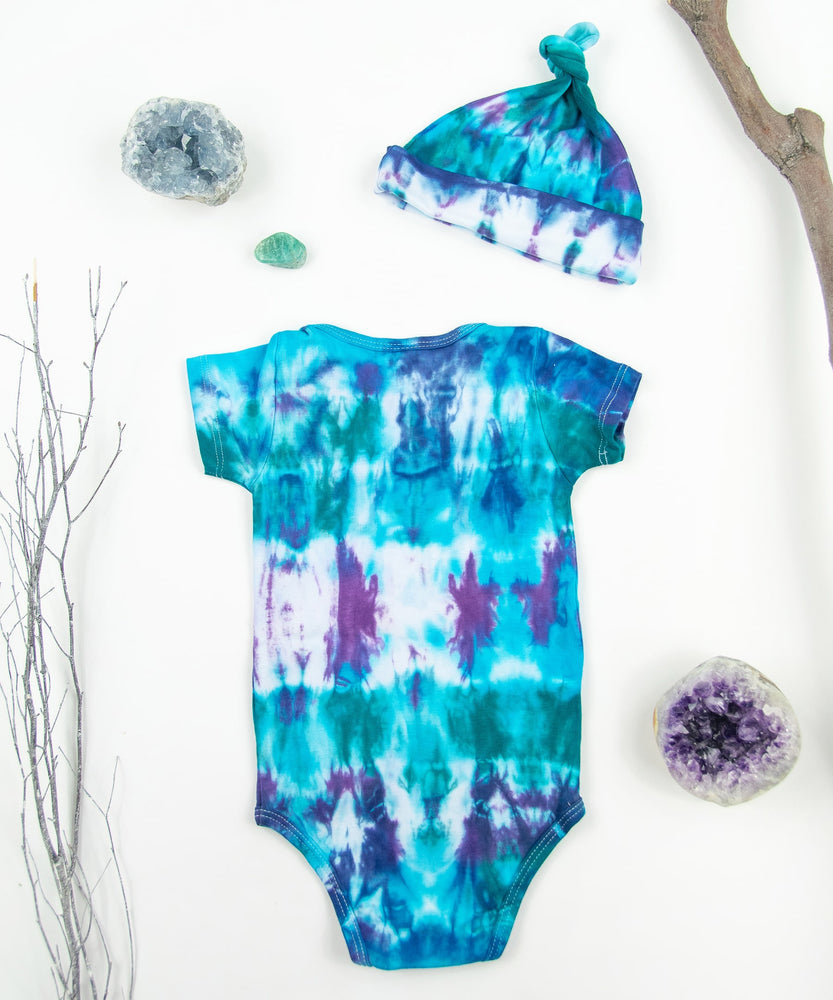 Blue, teal, and purple tie dye baby onesie and hat by Akasha Sun.