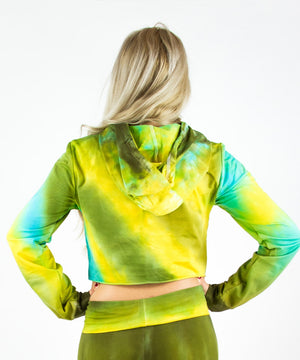 Woman wearing a tie dye hoodie crop top in green, yellow, and teal by Akasha Sun.