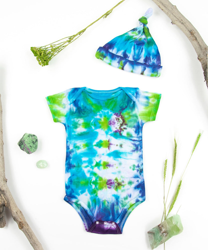 Teal, blue, green, and purple tie dye baby onesie and baby hat set by Akasha Sun.