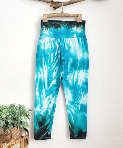 Teal tie dye yoga leggings with a wide waistband.