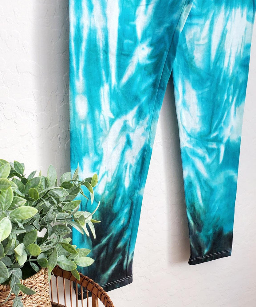 
                
                    Load image into Gallery viewer, Teal tie dye yoga leggings with a wide waistband.
                
            