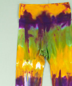 Green, purple, and yellow tie dye yoga pants with a wide waistband by Akasha Sun.