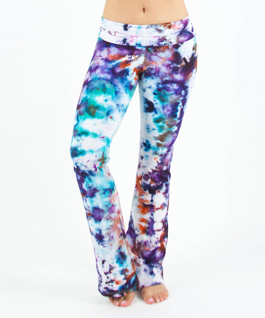Woman wearing a pair of rainbow tie dye yoga pants that have been ice dyed.