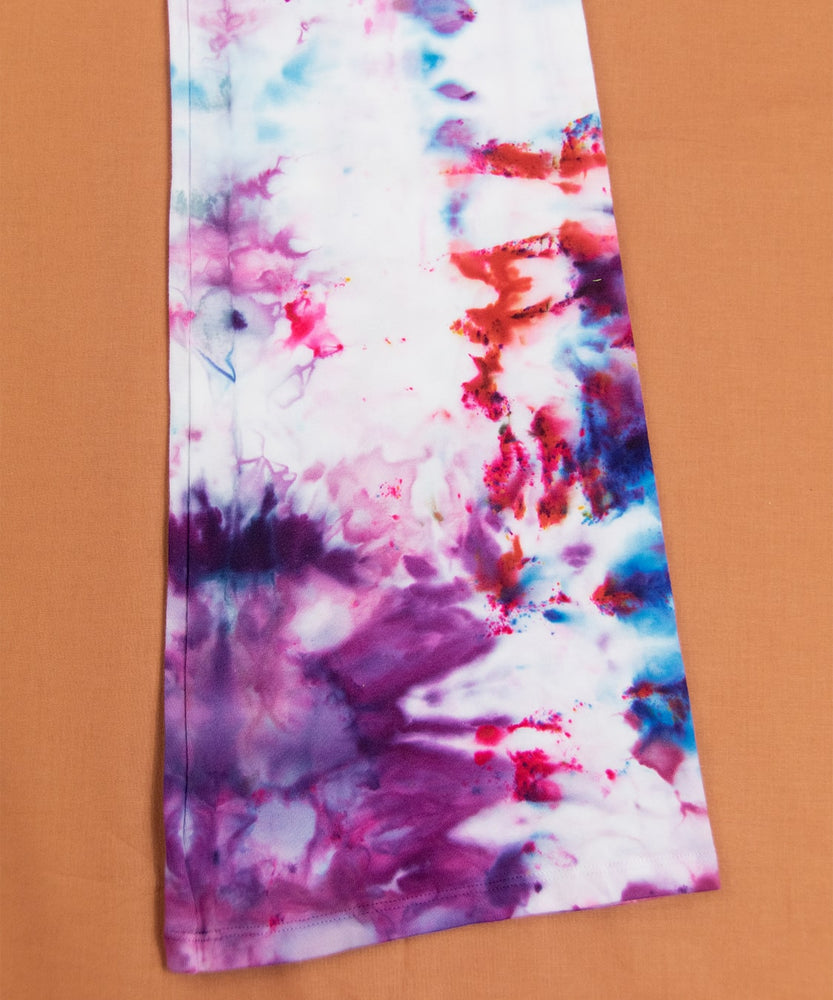 Ice dyed yoga pants in the colors purple, red, and blue.