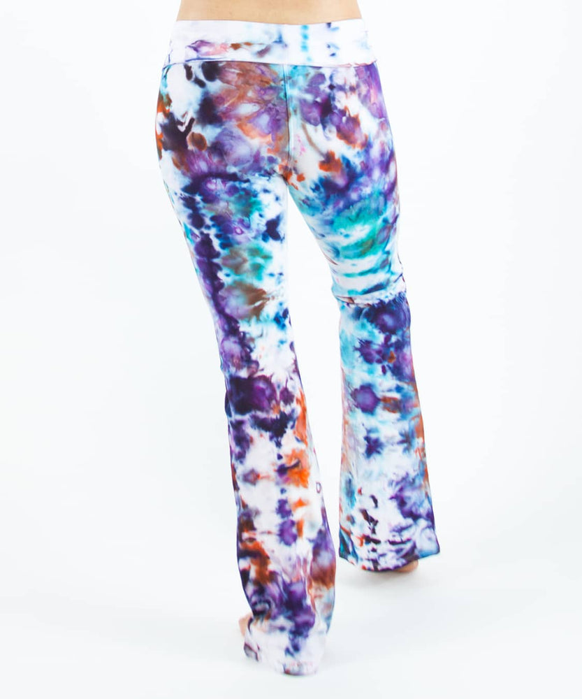Woman wearing a pair of rainbow tie dye yoga pants that have been ice dyed.
