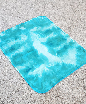 
                
                    Load image into Gallery viewer, An organic tie dye baby bodysuit, hat, and blanket set in aqua blue.
                
            