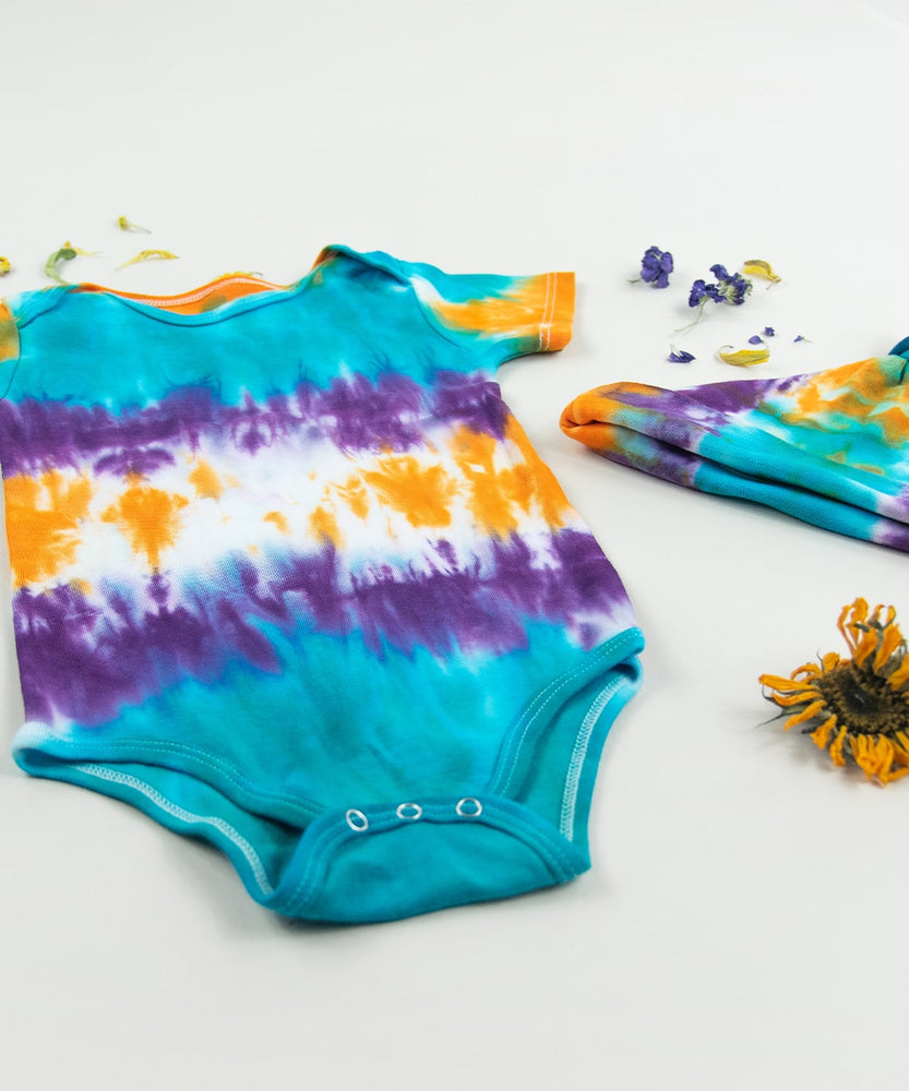 
                
                    Load image into Gallery viewer, Teal, purple, and orange tie dye organic cotton bodysuit and baby hat set by Akasha Sun.
                
            