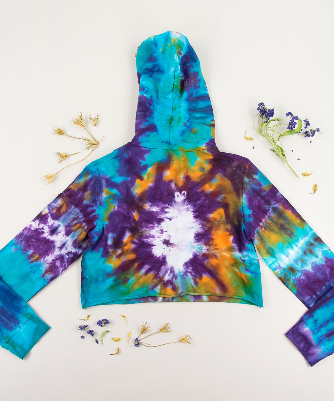 Purple, blue, and orange tie dye crop top hoodie by Akasha Sun.