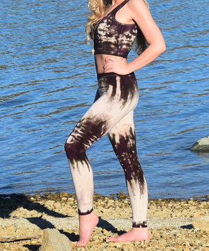 Woman wearing a pair of tie dye leggings by Akasha Sun in the colors cream and dark brown.
