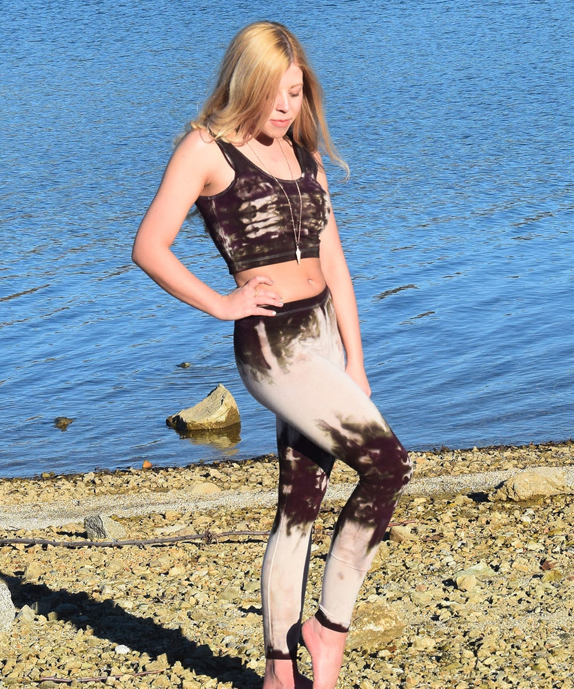 Woman wearing a pair of tie dye leggings by Akasha Sun in the colors cream and dark brown.