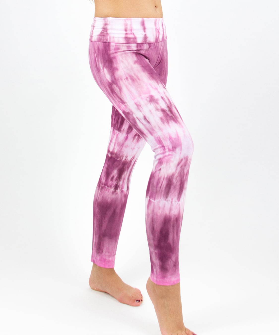 Woman wearing a pair of pink tie dye fold over leggings by Akasha Sun.