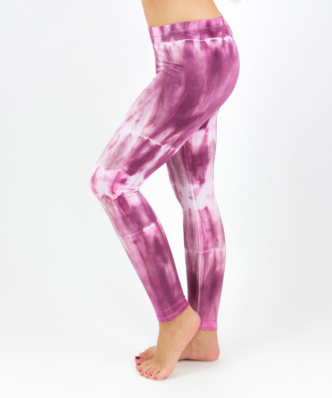 Woman wearing a pair of pink tie dye leggings by Akasha Sun.