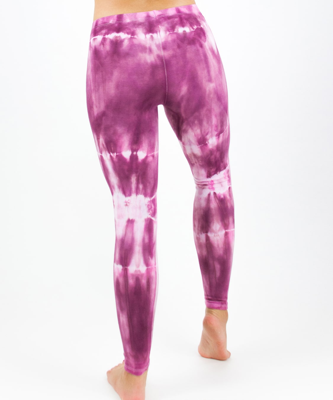 Woman wearing a pair of pink tie dye leggings by Akasha Sun.