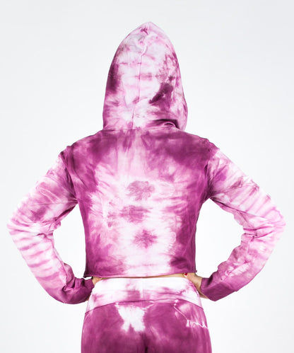 Woman wearing a pink tie dye crop top hoodie by Akasha Sun.