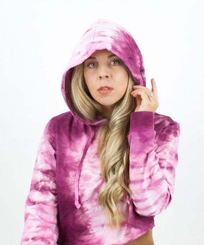 Woman wearing a pink tie dye crop top hoodie by Akasha Sun.