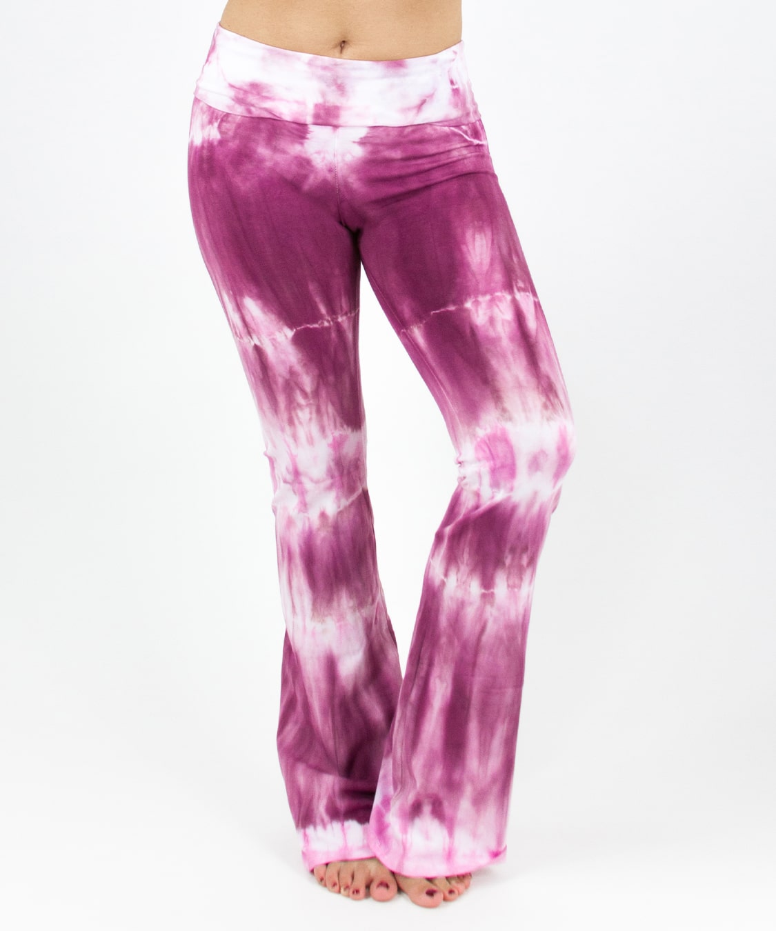 Woman wearing a pair of pink tie dye yoga pants featuring a fold over waistband by Akasha Sun.