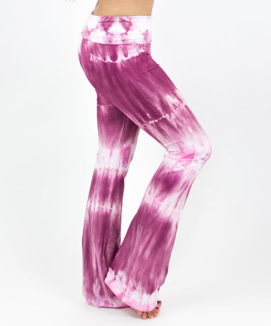 Woman wearing a pair of pink tie dye yoga pants featuring a fold over waistband by Akasha Sun.