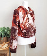 Rustic red and brown tie dye hoodie crop top with long sleeves.