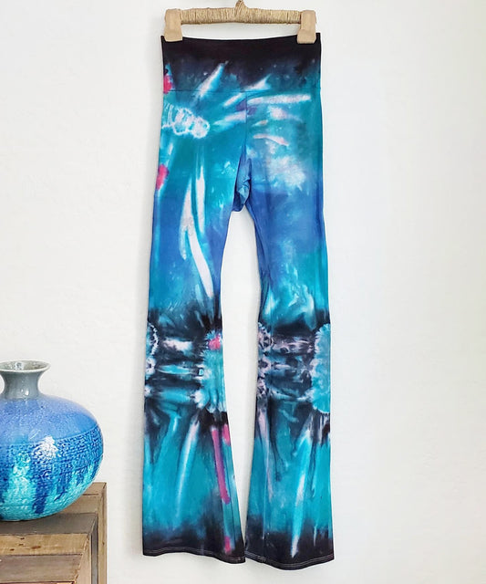 Teal, black, and blue tie dye yoga pants with a fold over waistband.