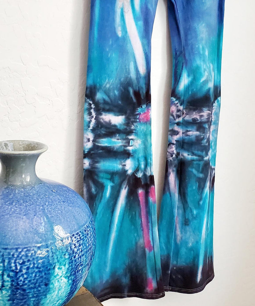 Teal, black, and blue tie dye yoga pants with a fold over waistband.
