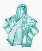 Children's tie dye jacket with a fleece interior, hood, pockets, and zipper.  The colors in the jacket are teal and white.