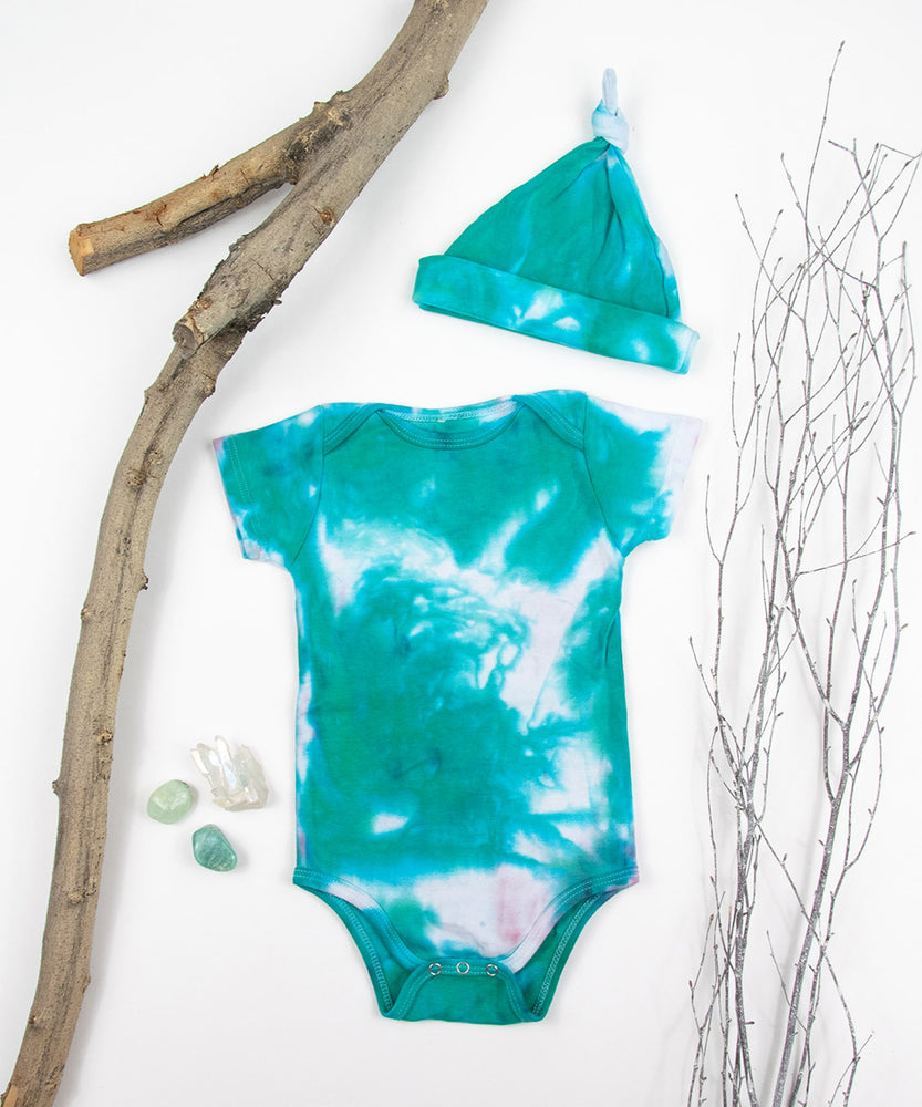 Teal and white organic tie dye bodysuit and baby hat set by Akasha Sun.