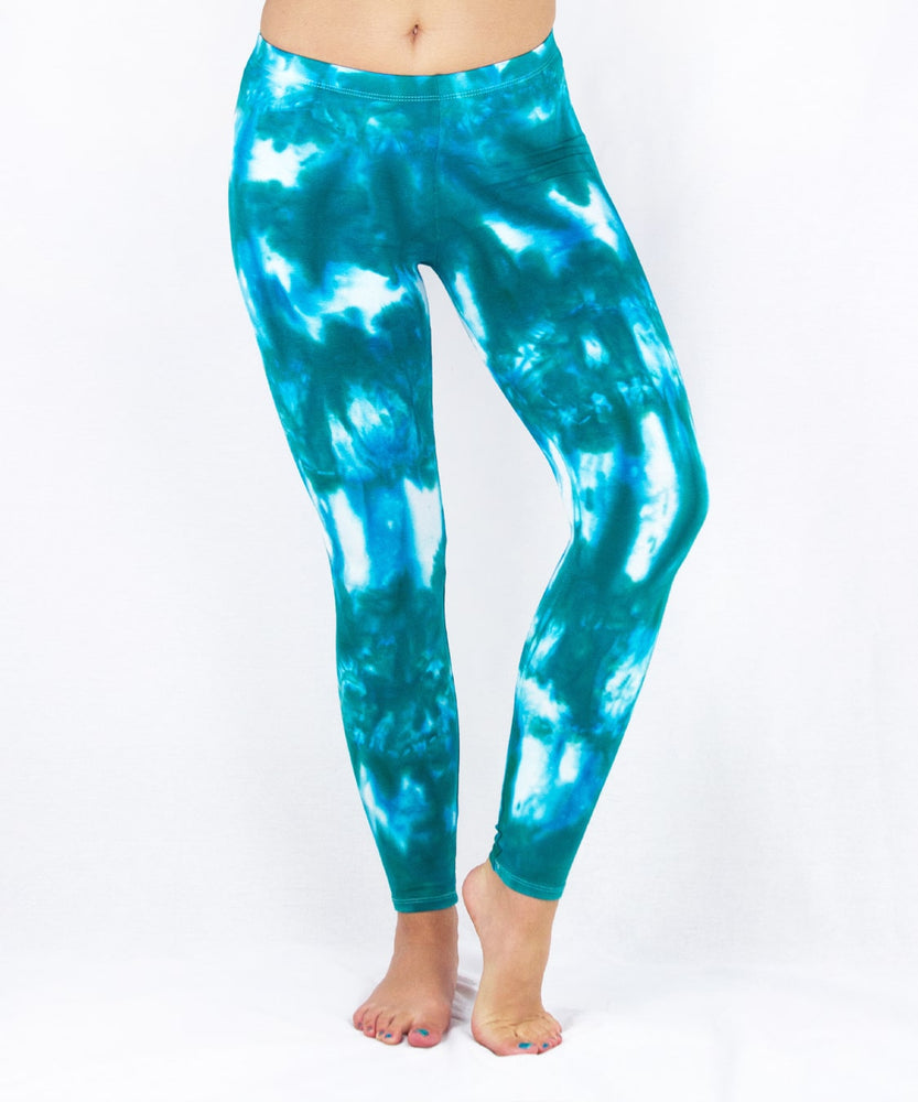 Woman wearing a pair of teal and white tie dye leggings by Akasha Sun.