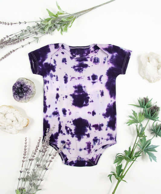 Purple tie dye onesie made of organic cotton.