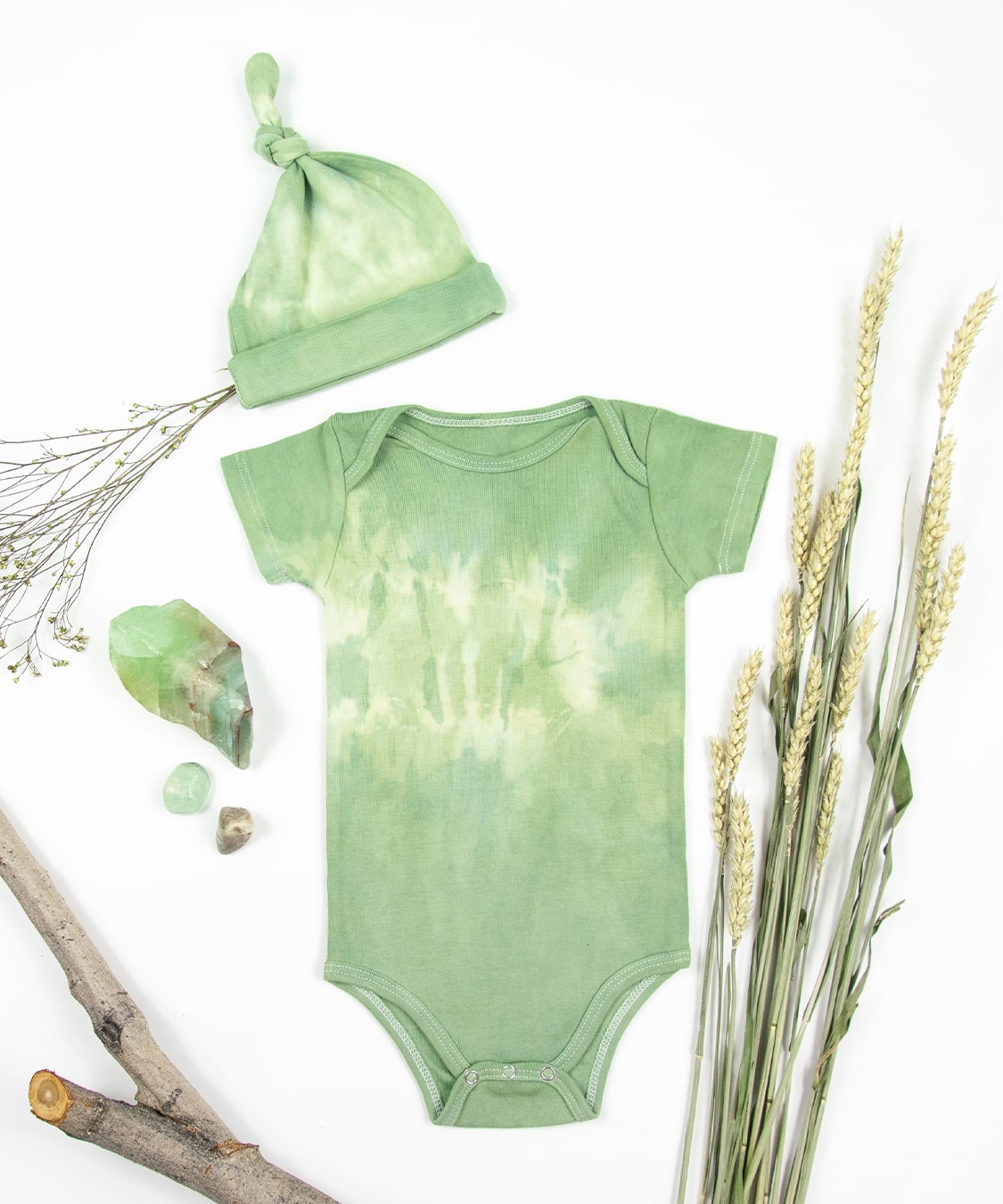 Green tie dye onesie and baby hat set made with organic cotton.