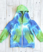 Blue and green tie dye baby zip up featuring a hood, fleece lining, and pockets.