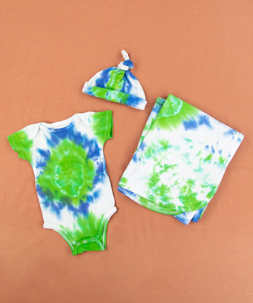 Blue, green, and white tie dye organic baby set that includes a baby blanket, bodysuit, and baby hat.