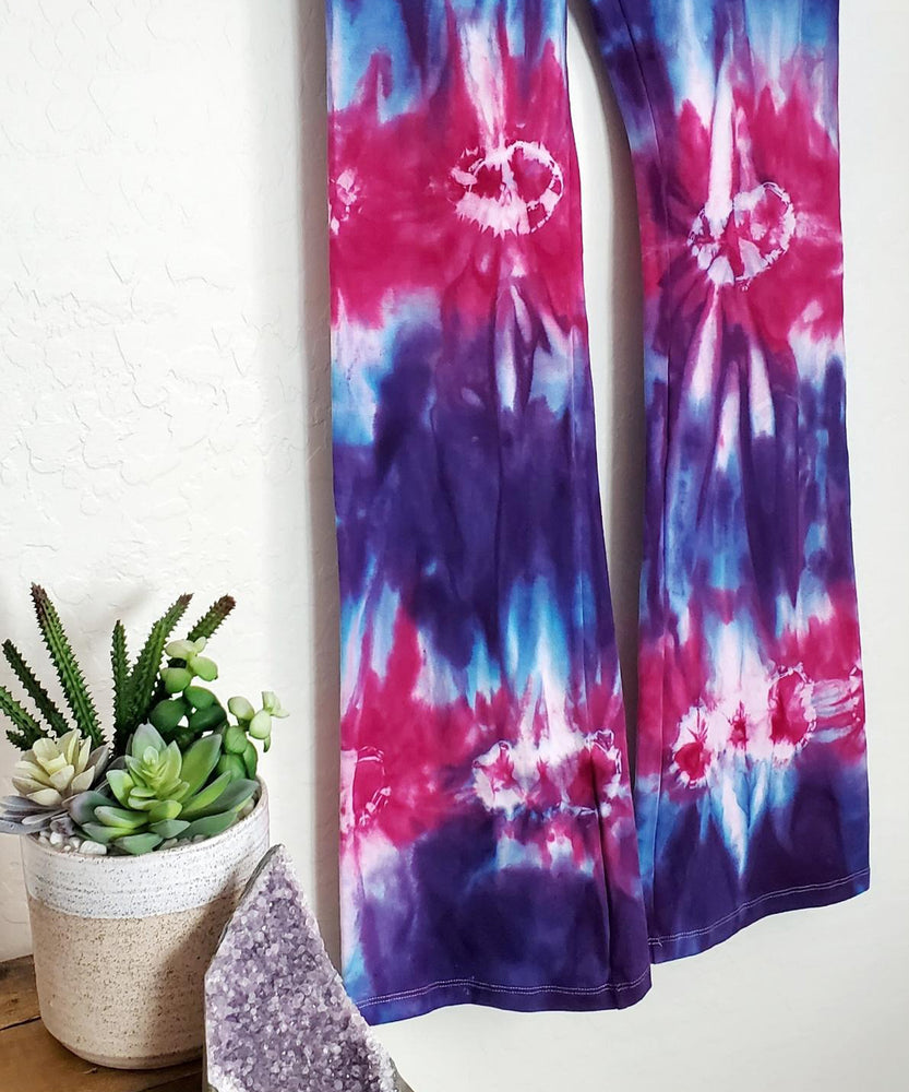 Purple and pink tie dye yoga pants with a wide waistband.