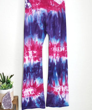 Purple and pink tie dye yoga pants with a wide waistband.
