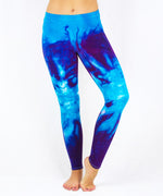 Woman wearing a pair of blue tie dye leggings by Akasha Sun.