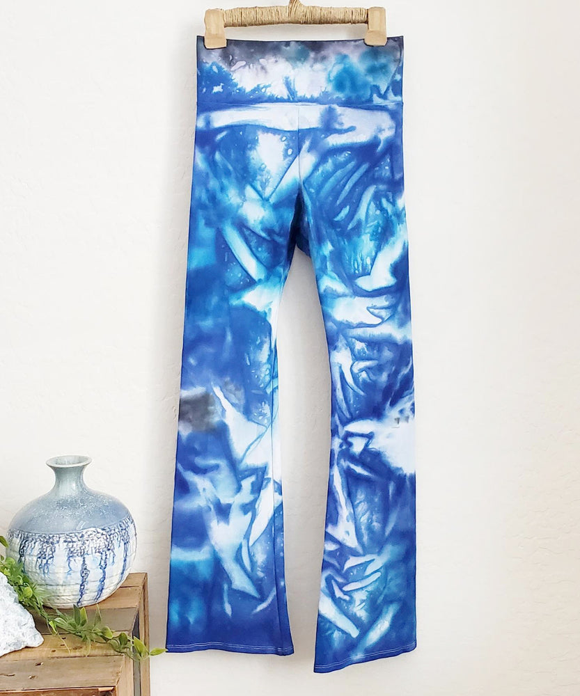 Blue and white tie dye yoga pants with a wide waistband.
