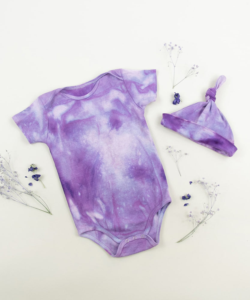 Purple organic cotton tie dye baby bodysuit and hat by Akasha Sun.