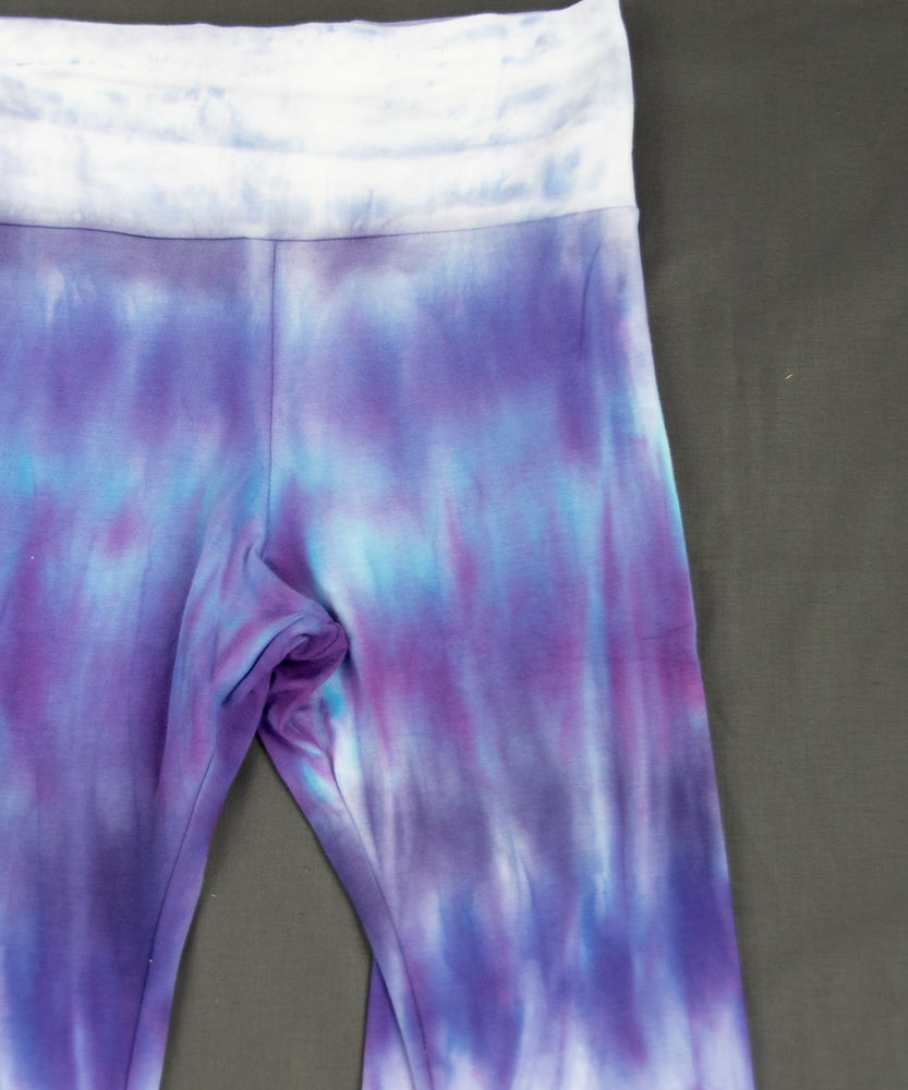 Lavender tie dye yoga pants with a wide waistband and flare bottoms.