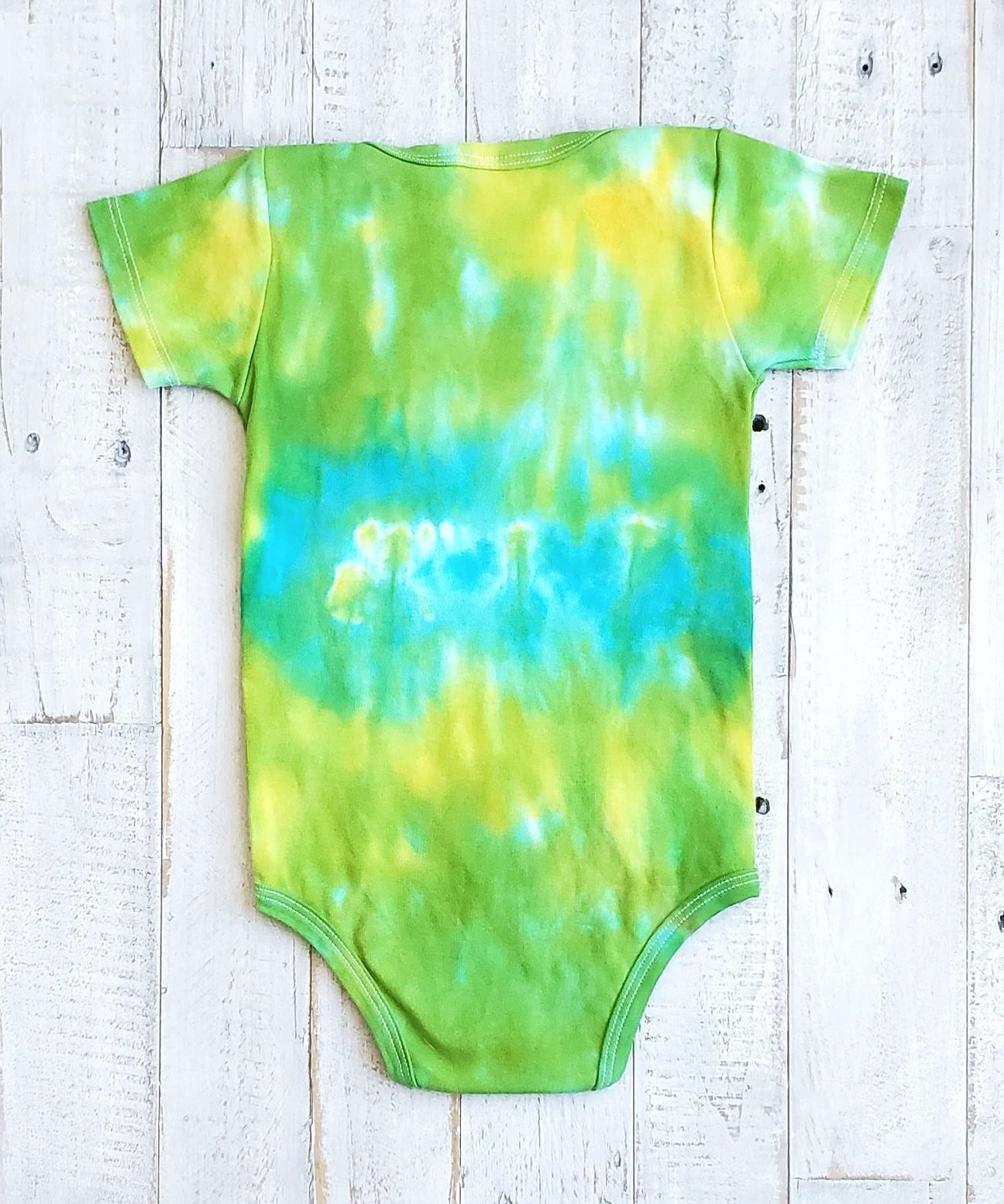 Green and aqua tie dye organic baby bodysuit.