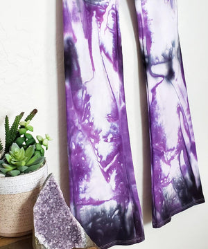 Purple and black tie dye yoga pants with wide waistband.