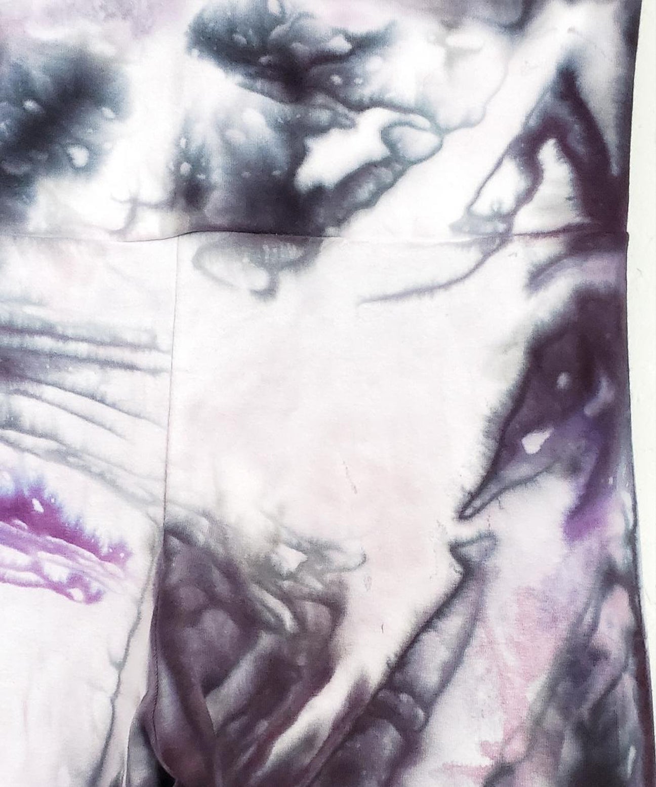 Purple and black tie dye yoga pants with wide waistband.