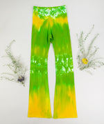 Yellow and green tie dye yoga pants with a wide waistband and flare bottoms by Akasha Sun.