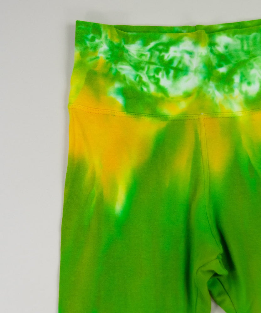 Yellow and green tie dye yoga pants with a wide waistband and flare bottoms by Akasha Sun.