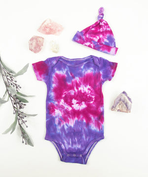 Organic purple and pink tie dye baby bodysuit and hat by Akasha Sun.