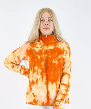 Woman wearing an orange tie dye jacket in a cadet style with zipper and pockets.