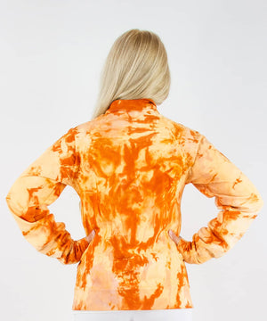 Woman wearing an orange tie dye jacket in a cadet style with zipper and pockets.