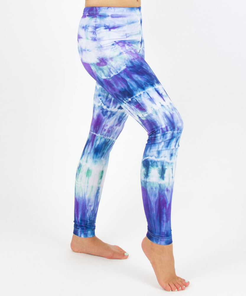 
                
                    Load image into Gallery viewer, Woman wearing the Mykonos tie dye leggings with the color blue, purple, light teal, and white.
                
            