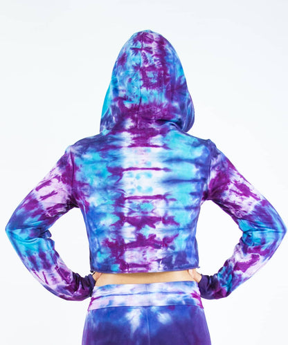 Woman wearing a purple and blue tie dye crop top hoodie by Akasha Sun.